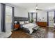 Spacious main bedroom with hardwood floors, a ceiling fan, and two large windows at 2020 Bixby Se St, Atlanta, GA 30317