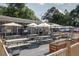 Large outdoor patio with picnic tables, umbrellas, and cafe lighting at 2020 Bixby Se St, Atlanta, GA 30317