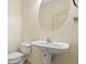 A pedestal sink and oval mirror accent this half bathroom at 2331 Suwanee Pointe Dr, Lawrenceville, GA 30043