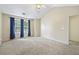 Bedroom with ceiling fan and windows with blue curtains at 2331 Suwanee Pointe Dr, Lawrenceville, GA 30043