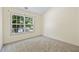 Bright bedroom featuring large window with view, neutral paint and carpet at 2331 Suwanee Pointe Dr, Lawrenceville, GA 30043