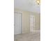 Bedroom with neutral walls and carpet leading to open ensuite and closet at 2331 Suwanee Pointe Dr, Lawrenceville, GA 30043