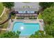 Aerial shot of community pool, clubhouse, lounge chairs, and manicured landscaping at 2331 Suwanee Pointe Dr, Lawrenceville, GA 30043