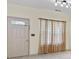 Bright entryway with tiled floors, neutral walls, and natural light from window with sheer curtains at 2331 Suwanee Pointe Dr, Lawrenceville, GA 30043