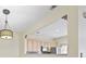 Sunlit kitchen area features a pass-through to the living room with a decorative pendant light fixture at 2331 Suwanee Pointe Dr, Lawrenceville, GA 30043