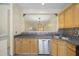 View of kitchen sink and dishwasher, with convenient pass through to living area at 2331 Suwanee Pointe Dr, Lawrenceville, GA 30043