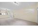 Open-concept living room with tiled floors and view to the kitchen from the large opening at 2331 Suwanee Pointe Dr, Lawrenceville, GA 30043