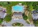 Aerial view of the community pool and clubhouse area with lounge chairs and tables around pool at 2331 Suwanee Pointe Dr, Lawrenceville, GA 30043