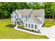 Sprawling home with a long driveway and well-manicured lawn surrounded by lush greenery at 445 Boulder Crest Trl, Villa Rica, GA 30180
