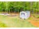 Aerial view of backyard storage shed with pathway and landscaping features in a well-maintained backyard at 445 Boulder Crest Trl, Villa Rica, GA 30180