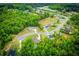 An aerial view showcasing the neighborhood, mature trees, and winding streets of the community at 445 Boulder Crest Trl, Villa Rica, GA 30180