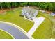 Aerial view of a landscaped property featuring a large home with a long driveway and well-manicured lawns at 445 Boulder Crest Trl, Villa Rica, GA 30180