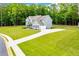 Sprawling home with a long driveway and well-manicured lawn surrounded by lush greenery at 445 Boulder Crest Trl, Villa Rica, GA 30180