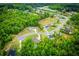 Aerial view showcases the community, lush greenery, and homes nestled within a vibrant landscape at 445 Boulder Crest Trl, Villa Rica, GA 30180