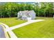 Spacious two-story home with an expansive lawn and a long driveway surrounded by mature trees at 445 Boulder Crest Trl, Villa Rica, GA 30180