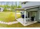Covered back patio with outdoor furniture and access to the lush backyard at 445 Boulder Crest Trl, Villa Rica, GA 30180
