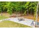 Stone backyard patio with a fire pit and seating area, perfect for outdoor enjoyment at 445 Boulder Crest Trl, Villa Rica, GA 30180