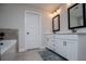 Clean bathroom featuring double sinks with white cabinetry and contemporary fixtures and finishes at 445 Boulder Crest Trl, Villa Rica, GA 30180