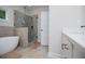 Bright and modern bathroom with a glass enclosed shower and a stand alone tub at 445 Boulder Crest Trl, Villa Rica, GA 30180