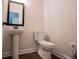 Clean bathroom with pedestal sink and modern toilet at 445 Boulder Crest Trl, Villa Rica, GA 30180