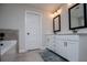 Well-lit bathroom with a double sink vanity and modern fixtures at 445 Boulder Crest Trl, Villa Rica, GA 30180