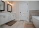 Bright bathroom with double vanities, modern fixtures, tile flooring and a stand alone tub at 445 Boulder Crest Trl, Villa Rica, GA 30180