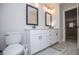 Bathroom with a double vanity, modern fixtures, and a view into the hallway at 445 Boulder Crest Trl, Villa Rica, GA 30180