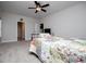 View of a carpeted bedroom featuring neutral walls, a ceiling fan, and access to other rooms at 445 Boulder Crest Trl, Villa Rica, GA 30180