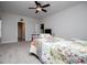 Bedroom features ceiling fan, carpet, and a bathroom at 445 Boulder Crest Trl, Villa Rica, GA 30180