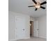 Well-lit bedroom featuring neutral carpet, a ceiling fan, and ample closet space at 445 Boulder Crest Trl, Villa Rica, GA 30180
