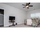 Relaxing bedroom with ceiling fan, television, and a comfortable bed with a patterned quilt at 445 Boulder Crest Trl, Villa Rica, GA 30180