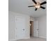 Neutral bedroom with a ceiling fan, and two white paneled doors at 445 Boulder Crest Trl, Villa Rica, GA 30180
