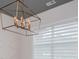 Dining room featuring geometric accent wall, modern chandelier and horizontal blinds at 445 Boulder Crest Trl, Villa Rica, GA 30180