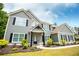 Inviting two-story home features a covered entryway, well-kept landscaping, and black trimmed windows at 445 Boulder Crest Trl, Villa Rica, GA 30180