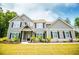 Charming two-story home with a welcoming entrance, manicured landscaping, and dark accent shutters at 445 Boulder Crest Trl, Villa Rica, GA 30180