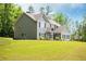 Beautiful two-story home featuring black shutters, gabled roof, covered porch and well-manicured lawn at 445 Boulder Crest Trl, Villa Rica, GA 30180