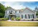 Inviting two-story home with gray siding, black shutters, landscaped front yard, and sidewalk leading to the entrance at 445 Boulder Crest Trl, Villa Rica, GA 30180