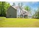 Two-story home with manicured lawn, established trees, complementary siding, and contrasting black shutters at 445 Boulder Crest Trl, Villa Rica, GA 30180