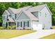 Charming gray two-story home with well-manicured lawn and inviting front entrance at 445 Boulder Crest Trl, Villa Rica, GA 30180