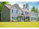Two story home featuring complementary siding, dark shutters, manicured lawn, and mature trees at 445 Boulder Crest Trl, Villa Rica, GA 30180