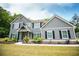 Charming two-story home featuring black shutters, gabled roof, covered porch and sidewalk at 445 Boulder Crest Trl, Villa Rica, GA 30180