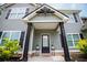 View of the home's entryway with pillars and plants at 445 Boulder Crest Trl, Villa Rica, GA 30180