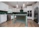 Modern kitchen with white cabinets, green backsplash, kitchen island and stainless steel appliances at 445 Boulder Crest Trl, Villa Rica, GA 30180