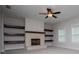 Spacious living room featuring a fireplace, floating wood shelving and lots of light at 445 Boulder Crest Trl, Villa Rica, GA 30180
