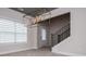 Open-concept living area featuring modern light fixture, large windows, and neutral paint, creating a bright and inviting space at 445 Boulder Crest Trl, Villa Rica, GA 30180