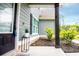 View of the home's entryway with a charming porch, decorative plants, and stylish accents at 445 Boulder Crest Trl, Villa Rica, GA 30180
