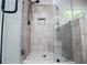 Modern glass enclosed shower with a tile surround and matte black fixtures at 445 Boulder Crest Trl, Villa Rica, GA 30180