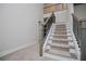 Staircase with carpet and dark banisters leads to the second story at 445 Boulder Crest Trl, Villa Rica, GA 30180