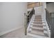 Stairway with carpeted stairs, white risers and wood railing at 445 Boulder Crest Trl, Villa Rica, GA 30180