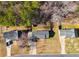 Aerial view displays house with driveway and neighboring properties and lawns at 447 Wallace Way, Rockmart, GA 30153